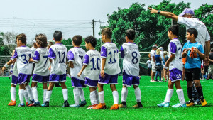 Allenatore e i ragazzini di una squadra di calcio